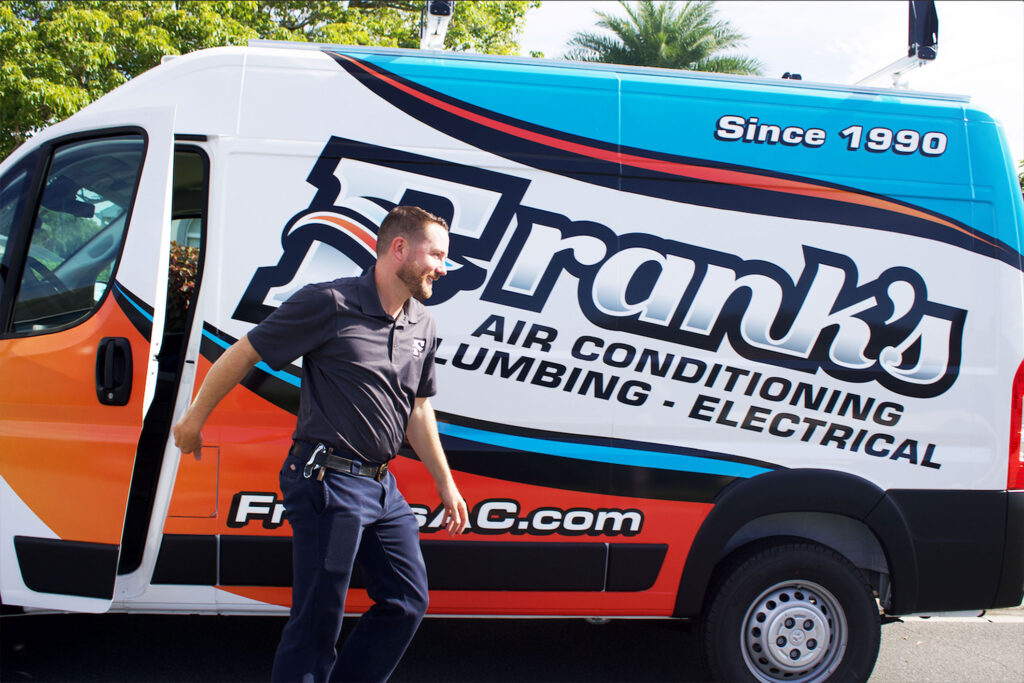 A Franks AC technician stepping out of his van
