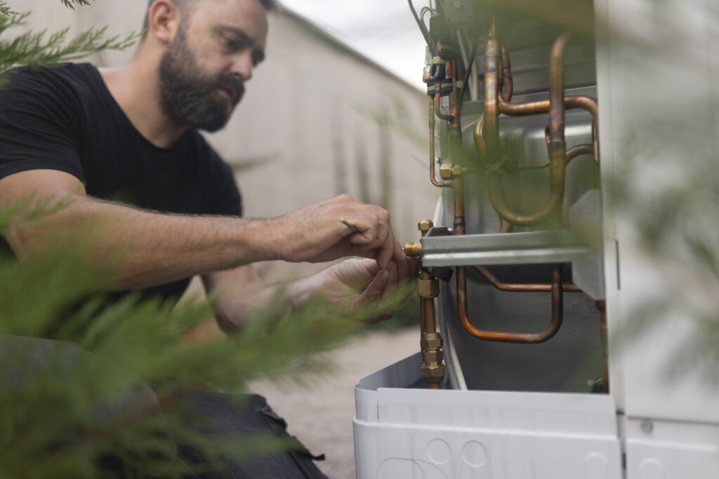Concentrated Man Installs A Heat Pump, Which Is Extremely Environmentally Friendly